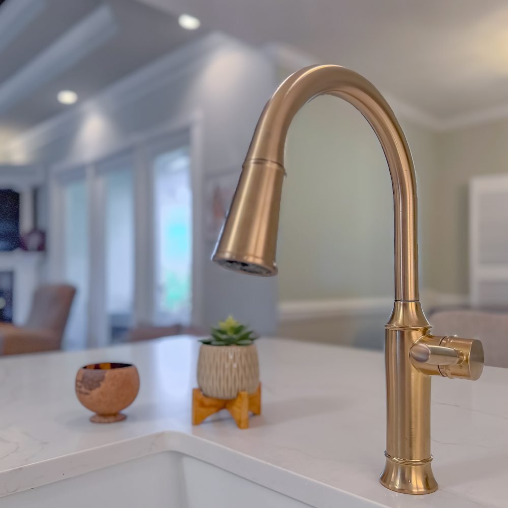Brass widespread faucet on a marble vanity top with an undermount basin