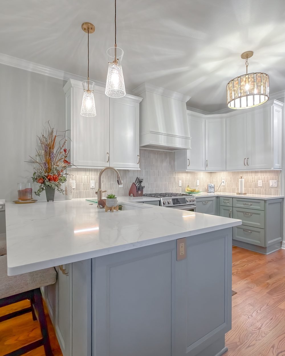 Renovated kitchen and dining space with sage inset cabinetry, quartz counters and brass hardware. Whole home renovation in Tallahassee, FL