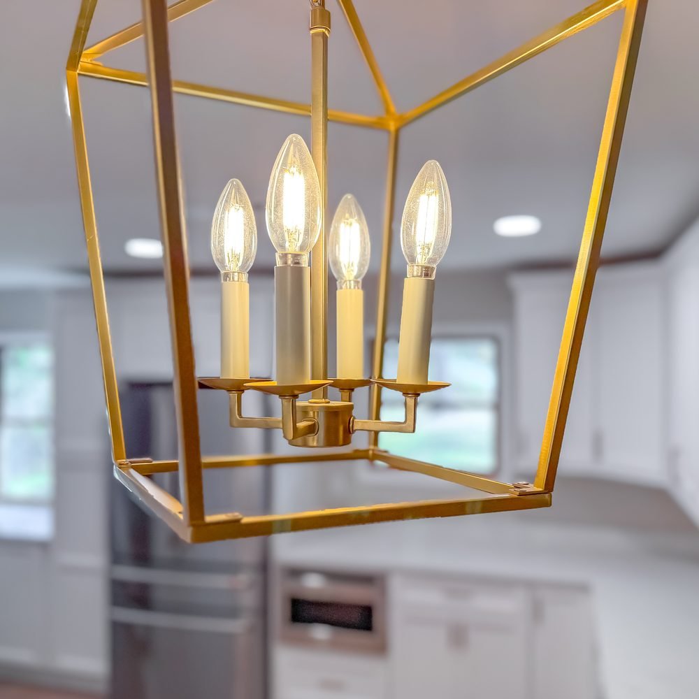 Aged brass lantern pendant hanging over a kitchen island