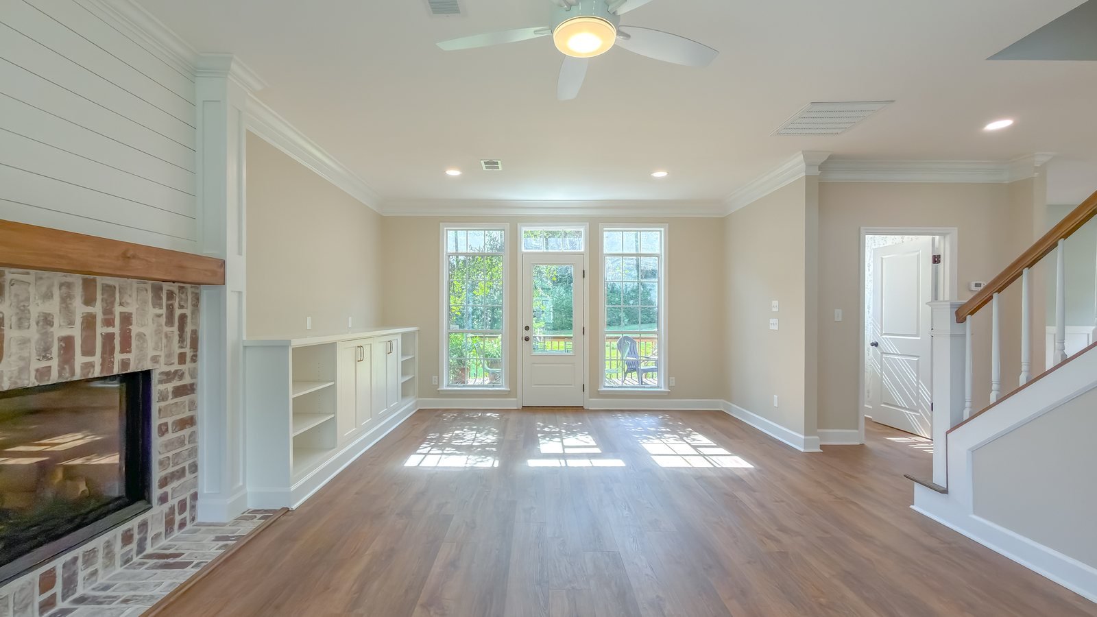 Living room with a brick fireplace and custom built-ins. Tallahassee, FL