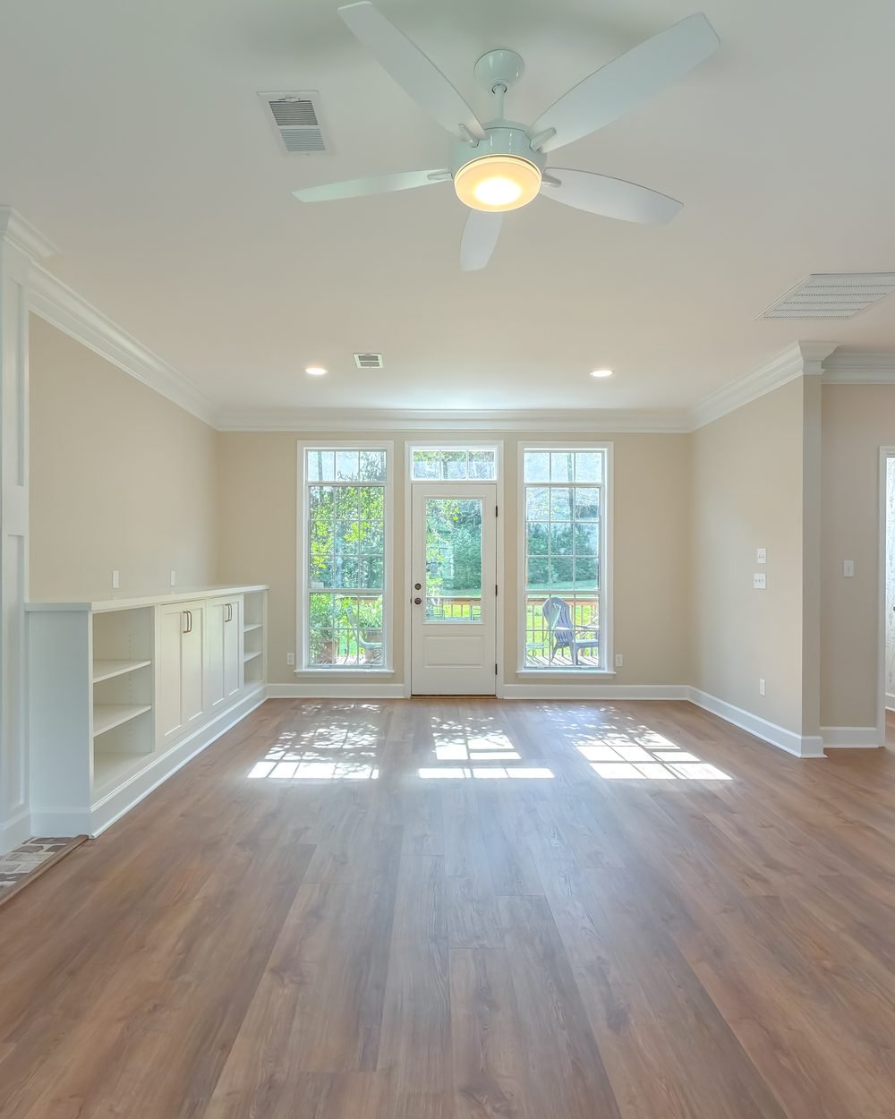 Living room with a brick fireplace flanked by custom built-in cabinetry. Tallahassee, FL