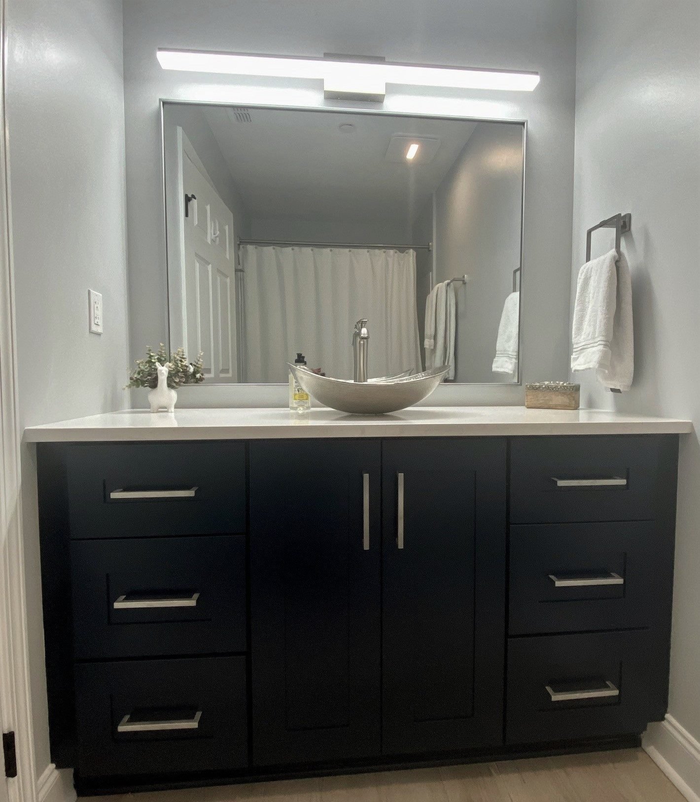 Espresso vanity with a vessel basin beneath a full-width mirror. Tallahassee, Florida.