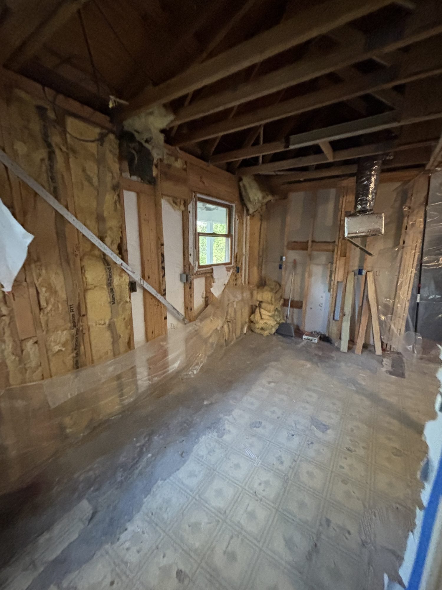 A room demolished to its wall studs and floor joists before structural work begins, Tallahassee, FL