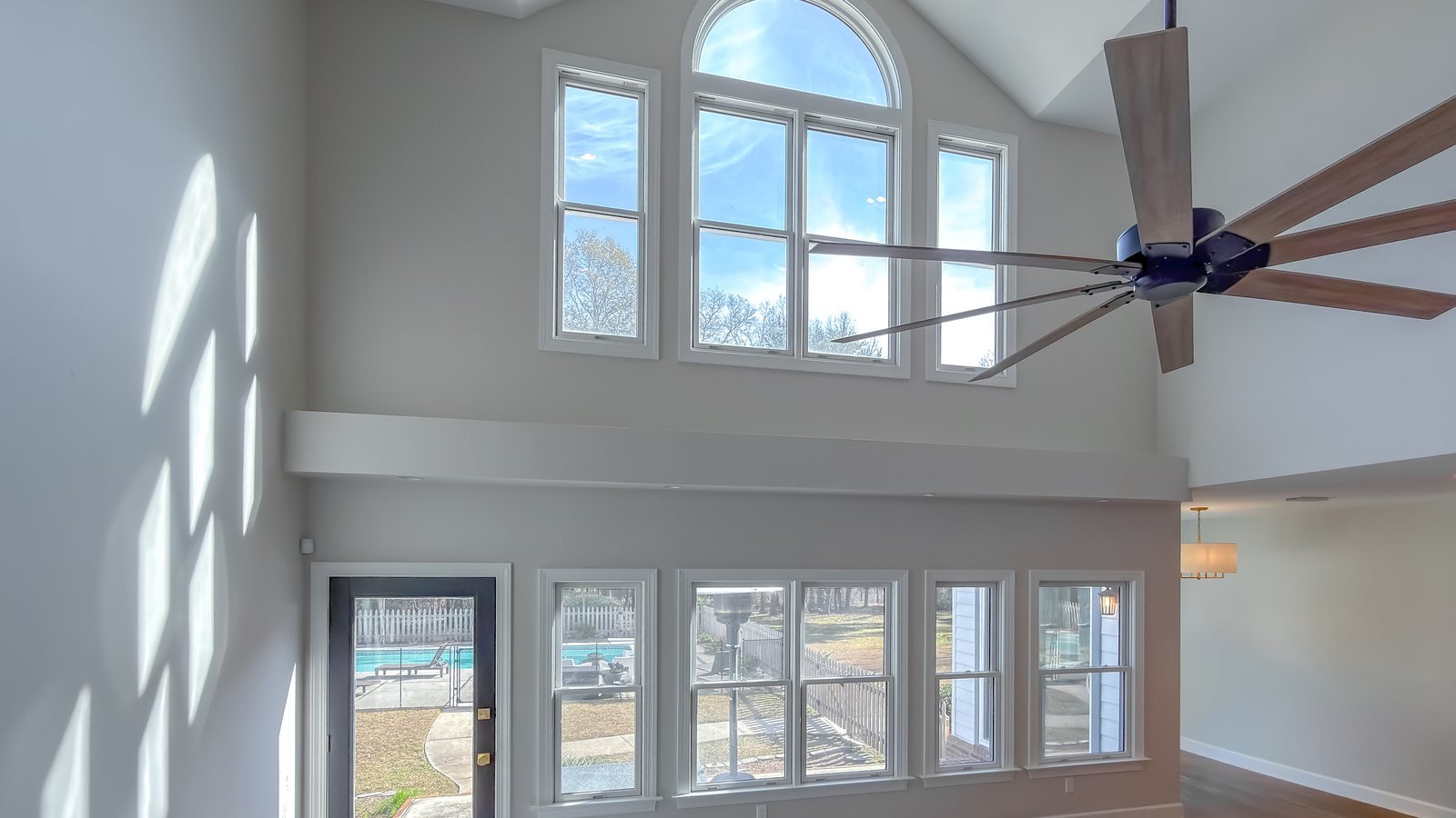 New living space with a vaulted ceiling and a full wall of windows. Pristine Renovations, Tallahassee, FL