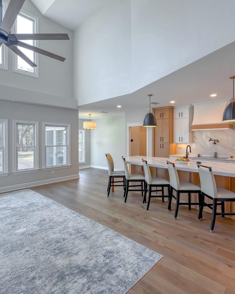 New double-height living space with a vaulted ceiling connecting to the existing house. Tallahassee, FL