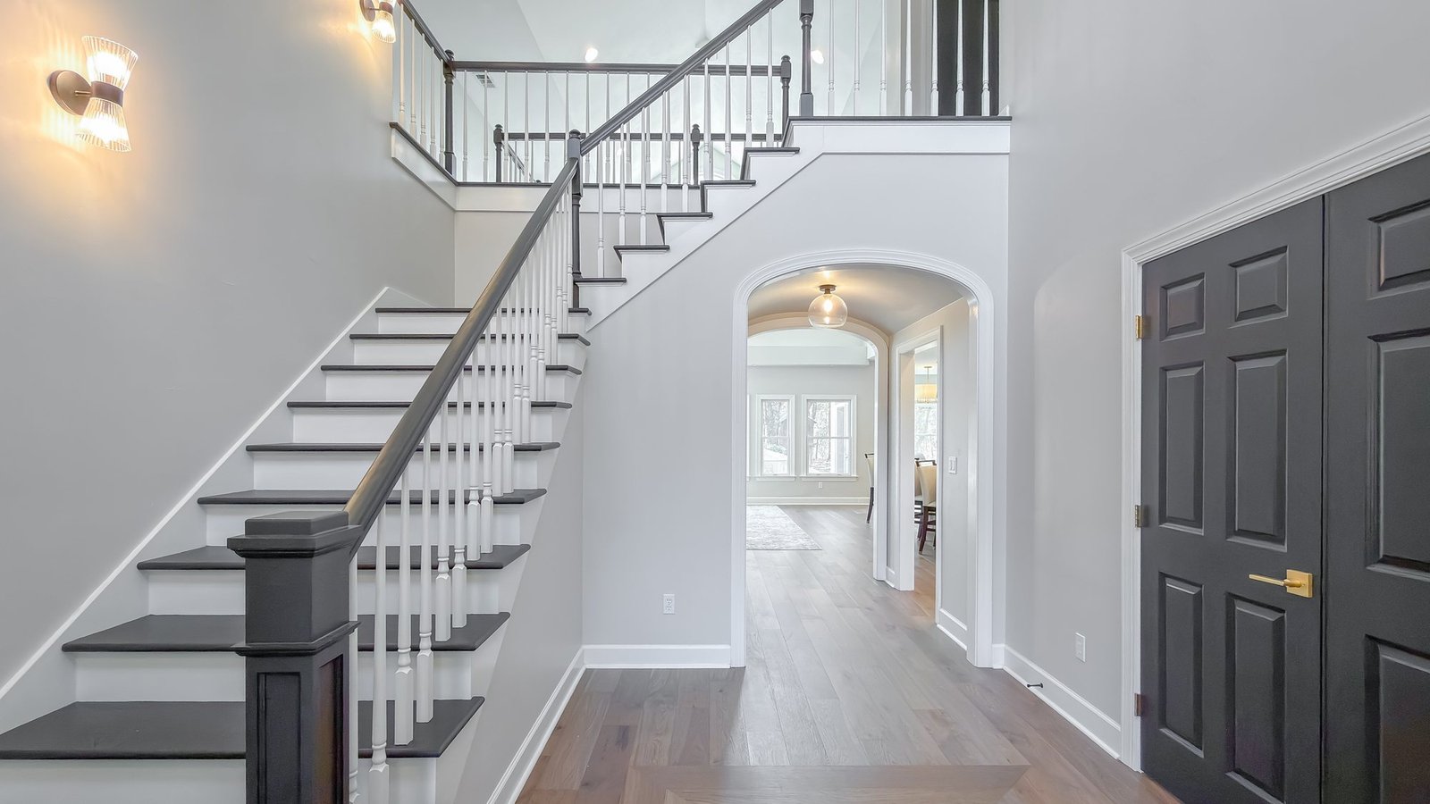 Staircase and two-story entry hall in a renovated Tallahassee home by Pristine Renovations