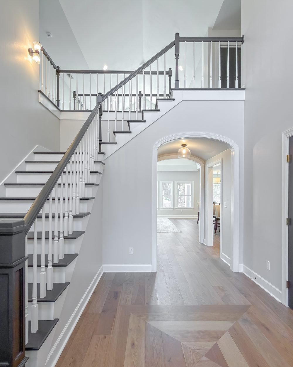 Staircase with white risers, dark treads and a painted newel post. Tallahassee, FL
