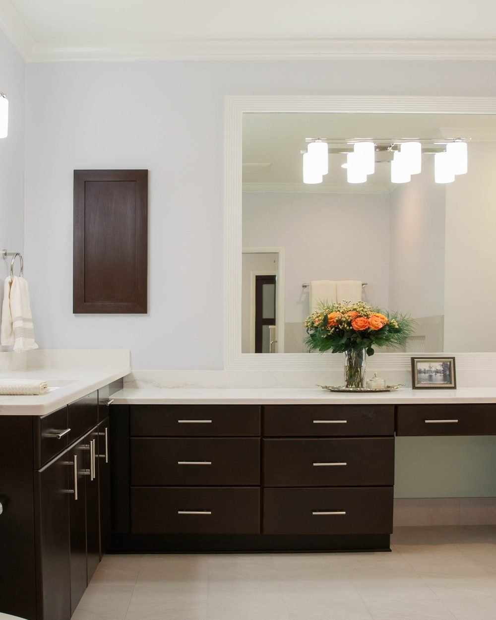 Primary bathroom with a dark espresso double vanity, white quartz and a freestanding soaking tub. Tallahassee, FL