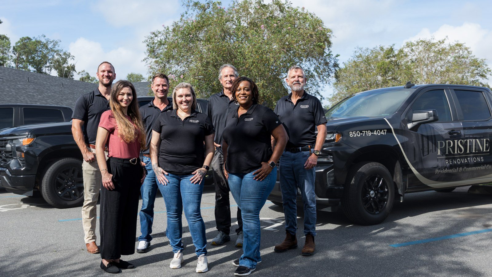 Pristine Renovations crew standing in front of company trucks