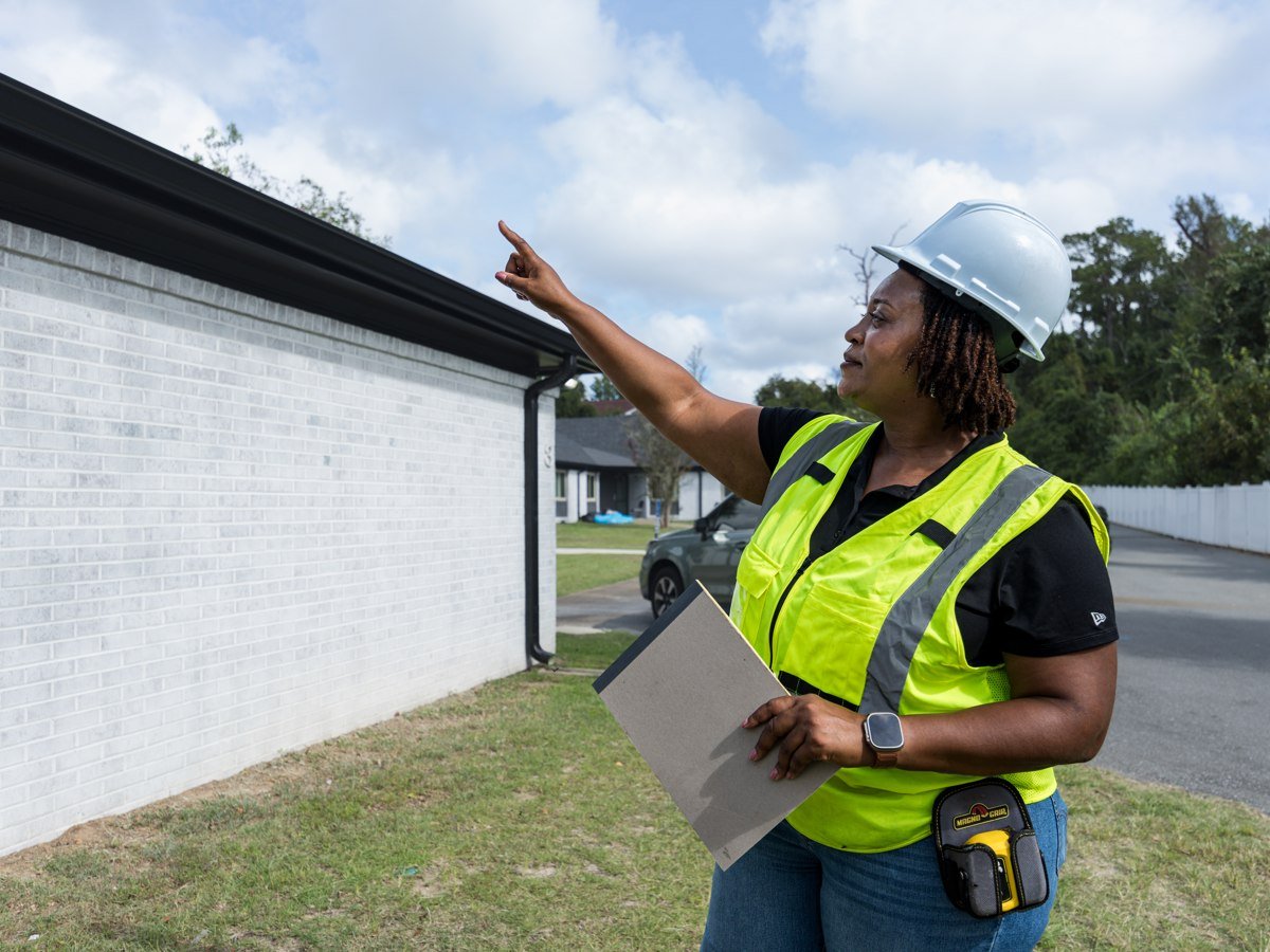 Pristine team member reviewing the exterior of a home with a clipboard