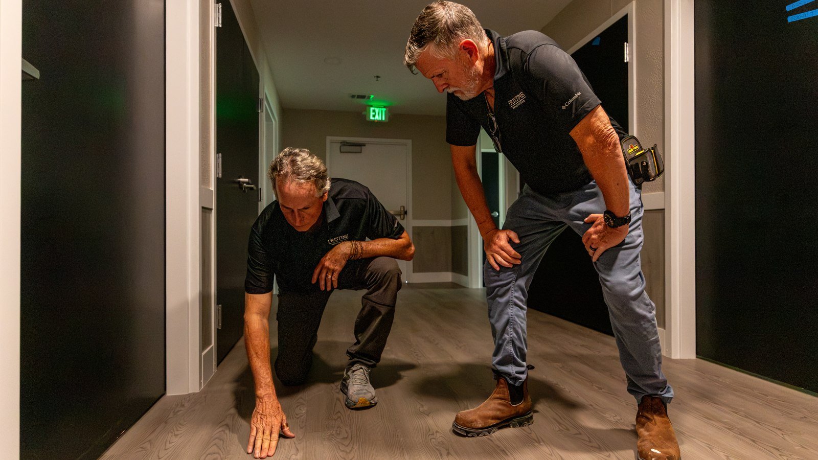 Pristine team members inspecting interior wall and floor details